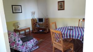a living room with a table and a couch at La Pievaccia in Binami
