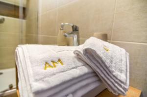 a bathroom with white towels on a sink at Apartmány Milovice in Milovice +22 photos