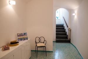 a room with a chair and a staircase at Dolce Pausa in Atrani +22 photos