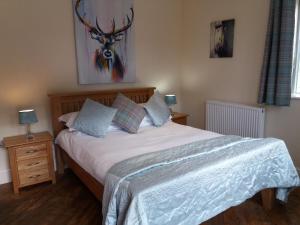 A bed or beds in a room at The Stables - Deer Park Farm 