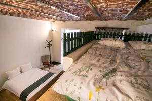 a bedroom with a large bed and a chair at Folkloric Loft-Ulița Românească in Sibiu