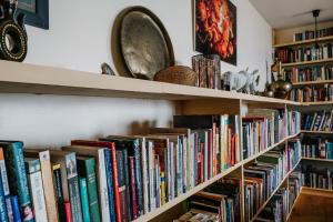a bunch of books on shelves in a room at EAGLE ROCK, near Skye in Strathcarron