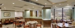 a dining room with tables and chairs in a restaurant at The Residency, Chennai in Chennai