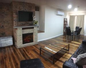 a living room with a fireplace and a tv at 3ree- Spacious & Charming Apartment in Devonport