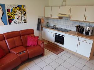 a living room with a couch and a kitchen at Ferienwohnung Sonnenfels **** in Bad Ems