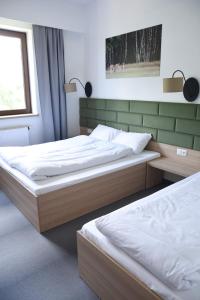 A bed or beds in a room at Lesna Perla Hostel de lux