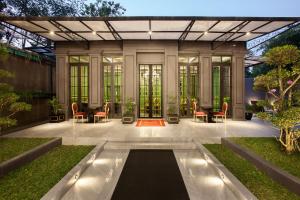 a house with a pool in the middle of a yard at Sofia Boutique Residence in Yogyakarta