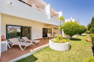 uma casa com um pátio com cadeiras e plantas em Victory Village 2A em Quinta do Lago