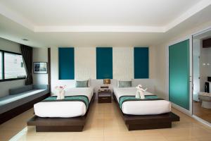 Postel nebo postele na pokoji v ubytování The Nice Krabi Hotel