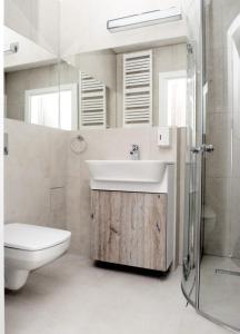 a bathroom with a sink and a toilet and a shower at Willa Cicho Sza in Pobierowo +29 photos