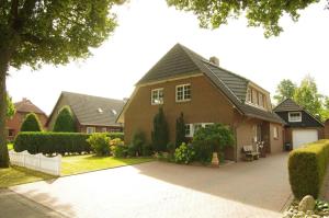 a house with a driveway in front of it at FeWo Haase in Westerstede