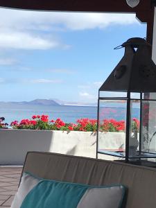 a view of the ocean from a patio with a lantern at Hotel Casa Del Embajador in Playa Blanca