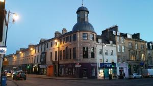 a building with a clock tower on the top of it at Cupar Burgh Chambers in Cupar