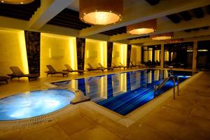 a pool in a hotel with a large swimming pool at Hotel Poezia in Luna