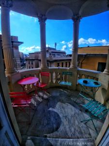 a view of chairs and tables on a balcony at Victoria House Hostel in Genoa