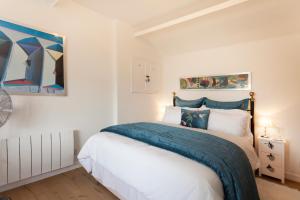 a bedroom with a bed with a blue blanket at Vale View Barn in Grantham