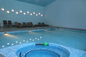 a swimming pool with a green ball in the middle at Lucytour Hotel in Hermon