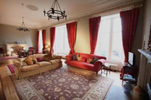 a living room with two couches and a red couch at Kinghorn Town Hall in Kinghorn