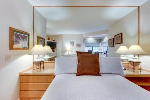 a bedroom with a large bed and two lamps at Seclusion in Century West in Bend