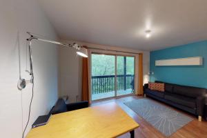 a living room with a table and a couch at Brighton #116 in Girdwood