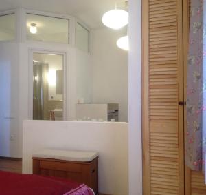 a bathroom with a mirror and a sink in a room at Studió Apartmanok in Balatonfüred +38 photos