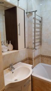a bathroom with a sink and a bath tub at Apartment on Nazarbayeva 77 in Almaty
