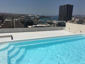 
a large swimming pool in the middle of a city at Piraeus Theoxenia Hotel in Piraeus
