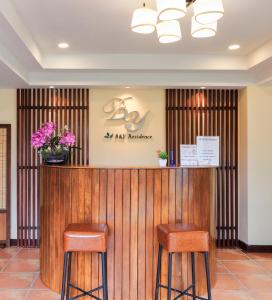 a bar in a lobby with two stools at B and Y Residence in Chiang Mai