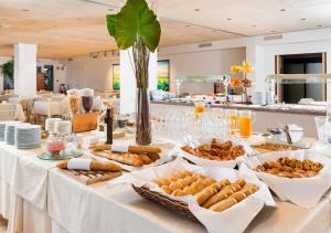 a buffet table with bread and pastries on it at Hotel & Spa Terraza 4 Sup in Roses