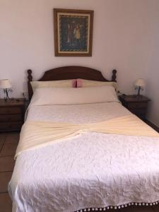 a bedroom with a large white bed with two night stands at El Time in Tijarafe