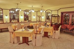 un comedor con mesas, sillas y espejos en Hotel Krone, en Alsfeld