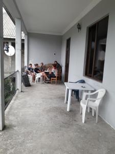 a group of people sitting at tables on a patio at kobuleti bagrationi 40 in Kobuleti