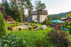 a garden with a playground and a house at Hotel Piatra Soimului in Sinaia