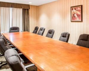 a conference room with a large wooden table and chairs at Econo Lodge Inn & Suites in Douglasville