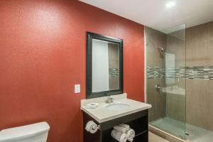 a bathroom with a sink and a glass shower at El Dorado Inn in Lynwood