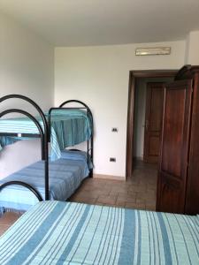 a bedroom with two bunk beds and a door at Agriturismo I Due Regni in Petrella Salto
