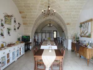 a kitchen and dining room with a table and chairs at Masseria San Martino in Fasano