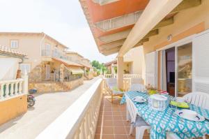 a patio with a table and chairs on a balcony at Aritja, 5 in Port d'Alcudia