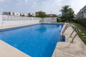 a swimming pool with blue water in a house at Golden in Playa de Gandia