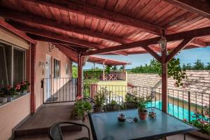 a patio with a table and a swimming pool at Aranypatkó Fogadó-Étterem in Győrújbarát