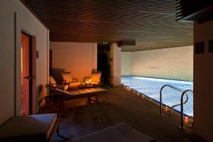 a living room with a swimming pool in a house at Grey Family Hotel in Kopaonik