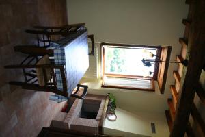 an overhead view of a staircase with a cat looking out the window at Agriturismo Oliveto di Geltrude Contessa in Amelia