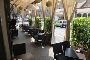 a restaurant with tables and chairs on a street at Kopernikus Hotel Prag in Belgrade