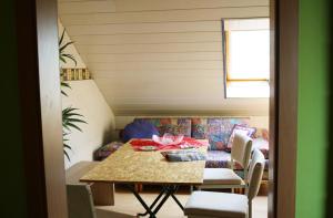 a dining room with a table and a couch at Monteurzimmer Beate Ackermann in Hochstadt am Main
