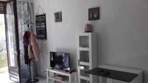 a living room with a tv and a tv stand at 15 C/MUGA-A EMPURIABRAVA in Empuriabrava