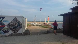 a person is flying a kite on the beach at 15 C/MUGA-A EMPURIABRAVA in Empuriabrava