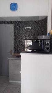 a kitchen with a counter and a clock on the wall at 15 C/MUGA-A EMPURIABRAVA in Empuriabrava