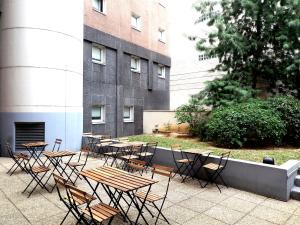 a group of tables and chairs in front of a building at ibis budget Paris Porte d'Italie Est in Le Kremlin-Bicêtre