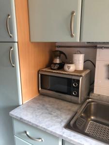 a kitchen with a microwave on top of a counter at Miky House in Rapallo