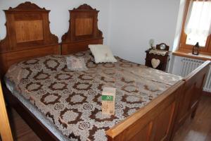 1 dormitorio con cama de madera y alfombra en Agritur Odorizzi, en Tassullo